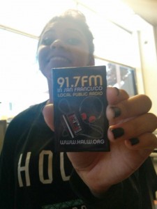 Noelia Gonzalez, a young engineer at Sunset Youth Services, shows off a magnet from one of her new favorite radio stations.